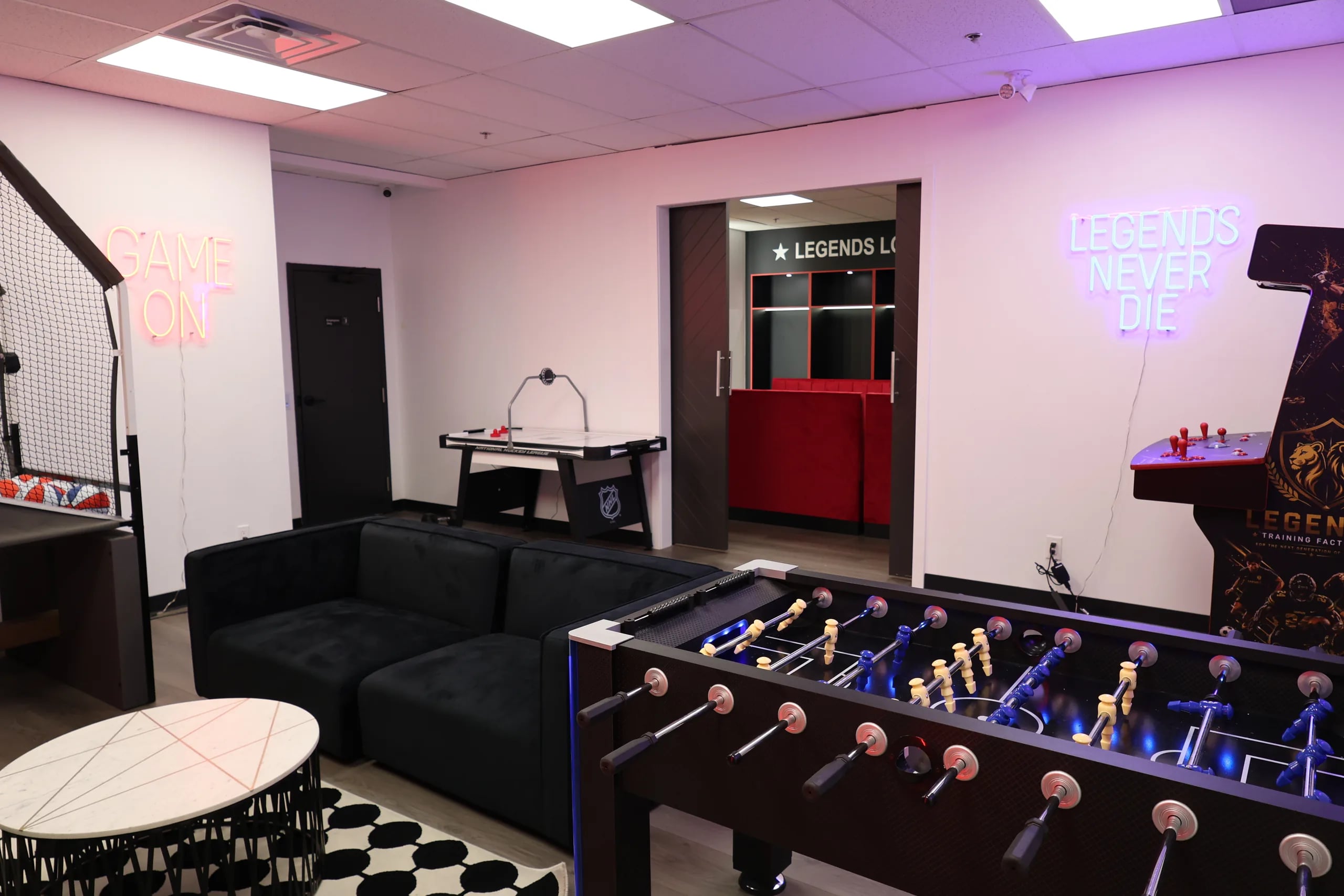 The party lounge at Legends Training Factory with foosball, air hockey, and arcade games.